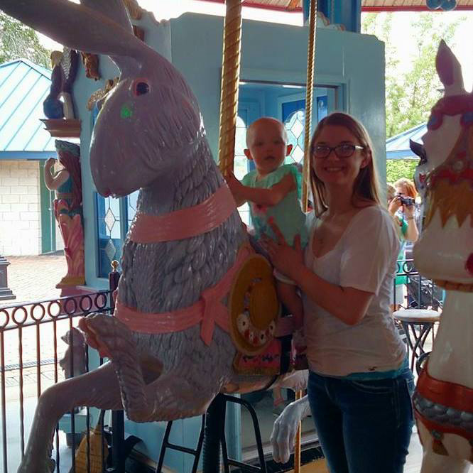 Erica with Arie on the carousel